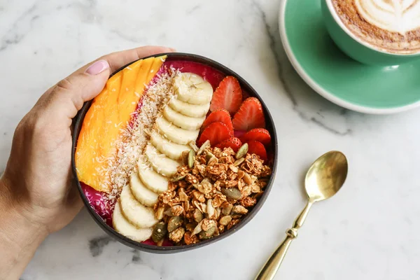 Smoothie bowl with strawberry, dragon fruit, mango and granola