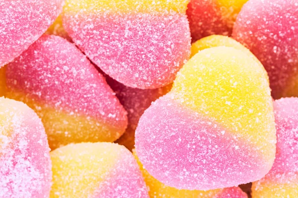 Bliska tło cukierków galaretki żółty i różowy pokryte s — Zdjęcie stockowe