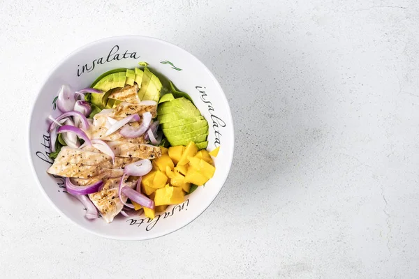 Grilled chicken, mango and avocado salad in deep salad bowl on l — 스톡 사진