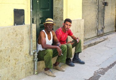 two Cuban men smoking during a siesta clipart