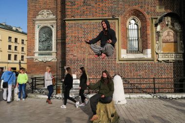  male levitation performance in the centre of Krakow clipart