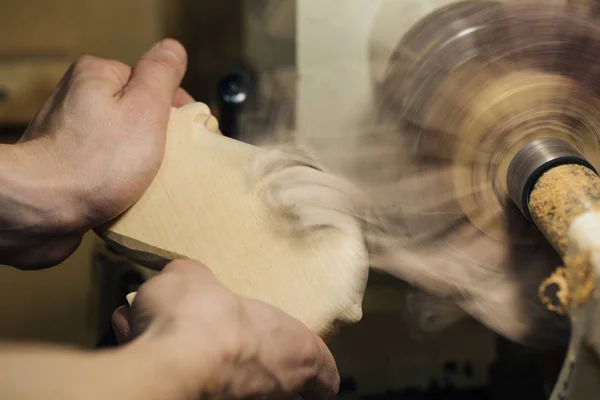 Sculpture sur bois, les mains du maître travaillent avec une surface en bois, un professionnel fait de l'artisanat du bois — Photo