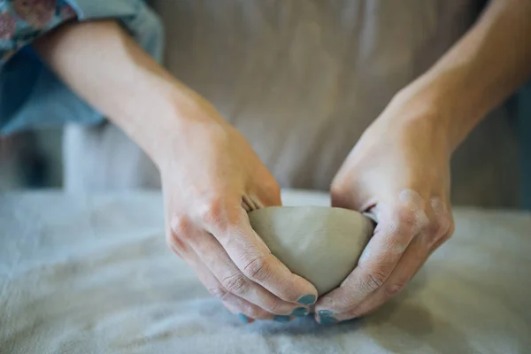 Hands make clay from various items for home and sale in the store and at the exhibition, ceramic items are made in hand, the clay billet becomes a ceramic dish, the ceramic master sculpts a beautiful product