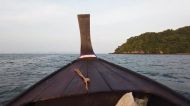 Uzun kuyruklu teknenin önü Tayland 'daki Krabi' de sabah su içinde yüzer.