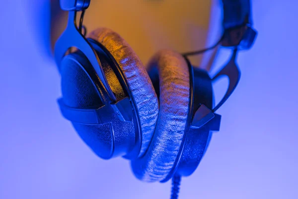 Professional headphones on blue purple background