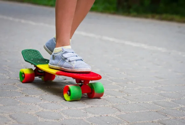 Adorável criança menino se divertindo com skate colorido ao ar livre no parque — Fotografia de Stock