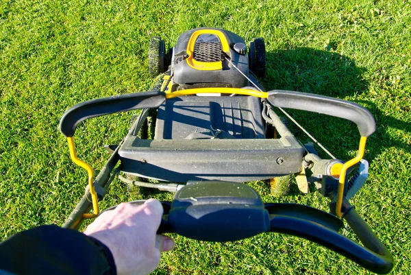 Person's perspective of mowing the lawn. — Stock Photo, Image