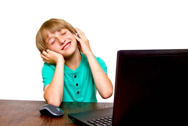 Boy using a laptop against a white background — Stock Photo, Image