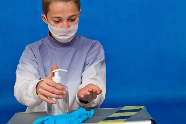 Young guy disinfecting hands with a sanitizer. Handwashing and hand hygiene during the covi pandemic 19.