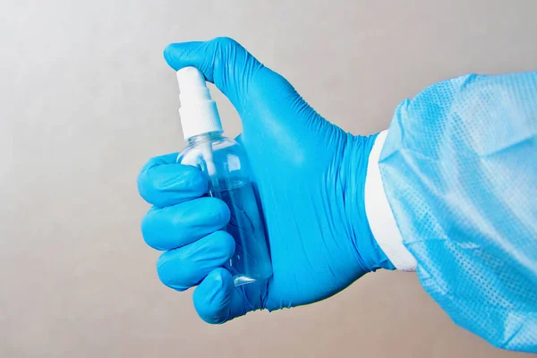 Sanitizer in a rubber glove. Disinfection of alcohol spray to prevent epidemic virus