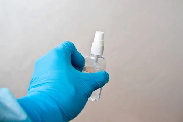 Sanitizer in a rubber glove. Disinfection of alcohol spray to prevent epidemic virus