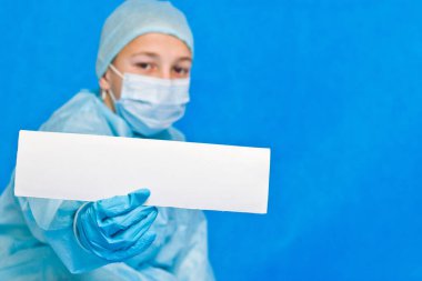 Genç doktor herhangi bir bilgi yazmak için beyaz boş kağıt gösteriyor.