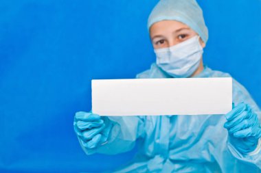 Genç doktor herhangi bir bilgi yazmak için beyaz boş kağıt gösteriyor.