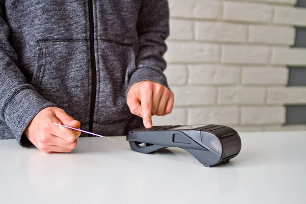 The process of payment for goods through the Terminal. Plastic card. Enter the password.