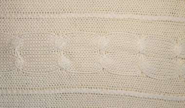 Beyaz yün doku ördü. Örgü desen 