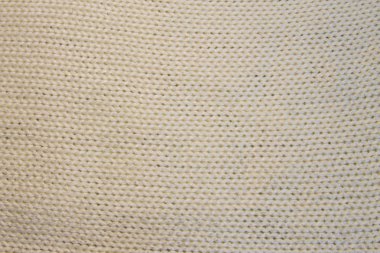 Beyaz yün doku ördü. Örgü desen 