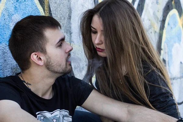 Young guy smokes near his girlfriend. Passive smoking