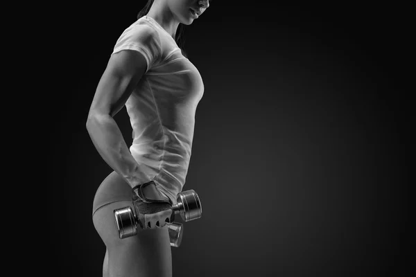 Female fitness model exercising with dumbbell — Stock Photo, Image