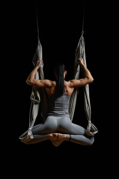 Back of young woman exercising aerial hammock yoga — Stock Photo, Image