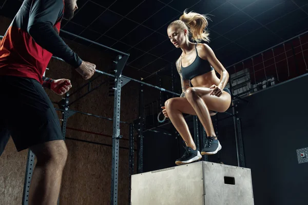 Vrouw doet box jump workout bij crossfit gym. — Stockfoto