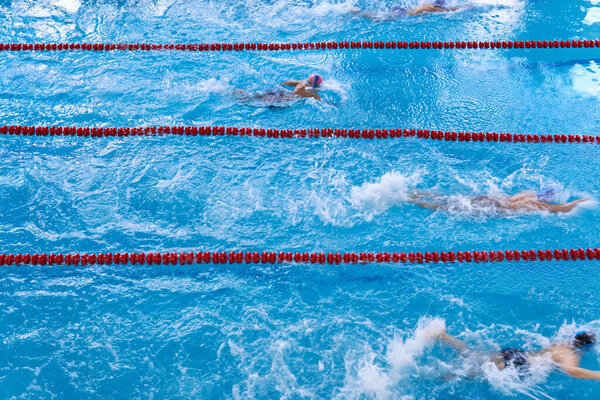 Young swimmers competition. Children swim in the pool.  Motion Top view 