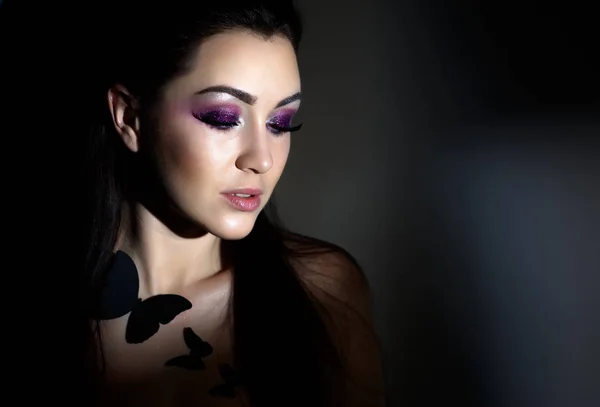 Divat modell nő a fény, fluoreszkáló make-up, gyönyörű modell-portré Art design színes alkotják. Hosszú színes barna hajú és világos make-up a gyönyörű fiatal nő portréja. — Stock Fotó