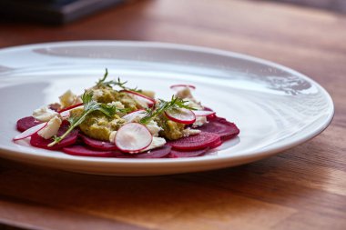 Taze tatlı bebek ıspanak, lahana marul, fındık, beyaz peynir ve tost ile sağlıklı pancar salatası erimiş. Pancar, closeup ile taze salata. Kase salata için rustik ahşap masa üzerinde doğranmış kırmızı pancar (pancar). 