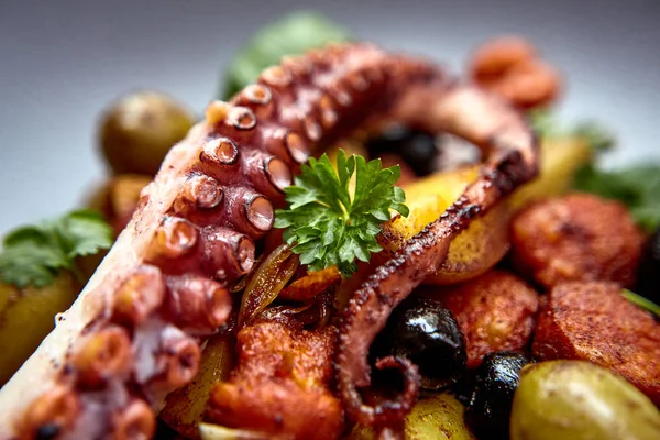 The process of eating the delicious grilled octopus. jukkumi bokkeum is korea traditional webfoot octopus with vegetable stir fry. — Stock Photo, Image