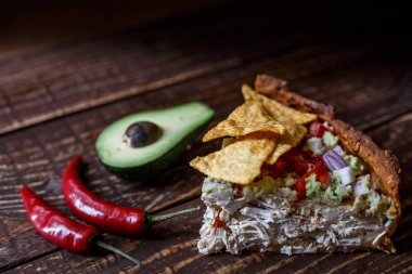 Avustralya etli börek tablo ve avokado, biber, patates bir yatay üstten görünüm, rustik tarzı. Ahşap masa portre üzerinde ev yapımı Avustralya etli börek. Lezzetli bir plaka üzerinde et pastası kesti. Amerikan Tavuklu paçanga böreği masaya pişirme çanağı içinde.