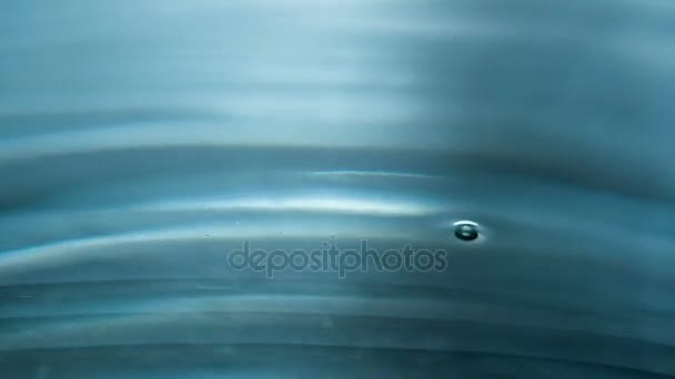 晶莹清澈的水滴 一滴液体慢慢落在水面上 一个美丽的飞溅和水上的圆圈 以240Fps 的速度拍摄 — 图库视频影像