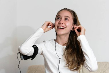 Akıllı telefon ve giyen kulaklık ile genç genç kız