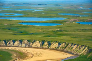 Landscape of the arctic tundra in summer. Rivers, lakes, northern vegetation. View from above. The concept of climate change, warming in the Arctic. clipart