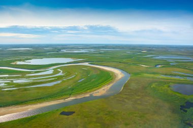 Landscape of the arctic tundra in summer. Rivers, lakes, northern vegetation. View from above. The concept of climate change, warming in the Arctic. clipart