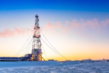 Winter polar day in the arctic. Drilling a well at a northern oil and gas field. Low sun. Beautiful lighting.
