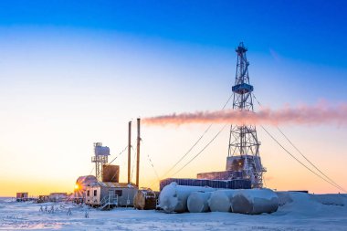 Winter polar day in the arctic. Drilling a well at a northern oil and gas field. Low sun. Beautiful lighting.