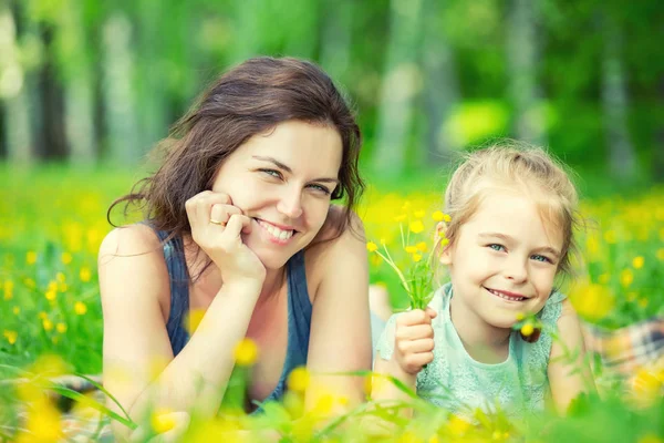 Mother and daughter on sunny meadow — Stock Photo, Image