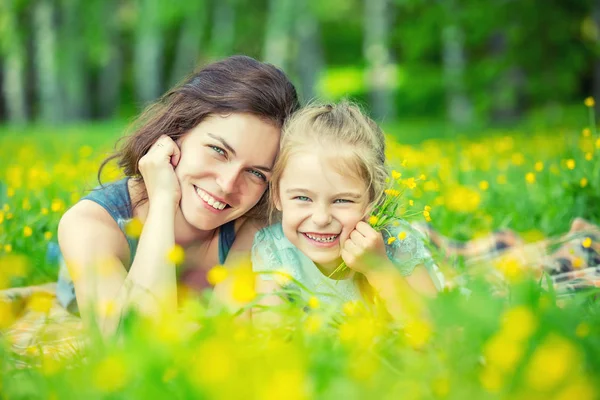 Mother and daughter on sunny meadow — Stock Photo, Image