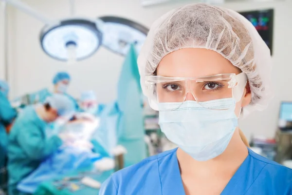 Young Female Surgeon with Medical Team in Back on Surgery — Stock Photo, Image