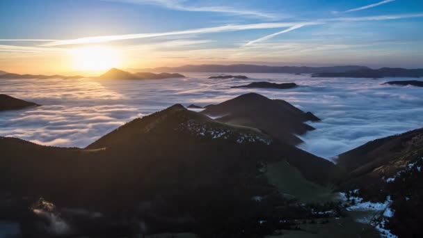 Colorful sunrise morning above mist clouds flows in mountain valley time lapse — Stock Video