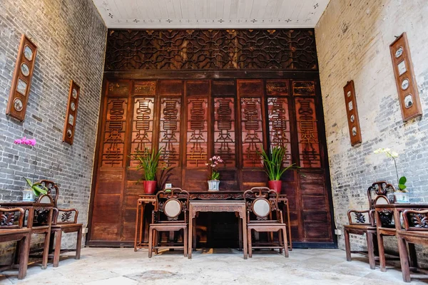 Traditional oriental chinese heritage building, wood table, chair and decorate with beautiful orchid in Macao/Macau, China