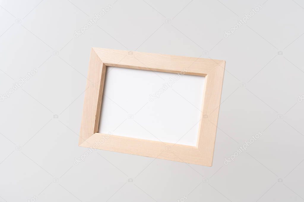 Design concept - top view of wood photo frame float on mid air and isolated on white background for mockup, it's real photo, not 3D render