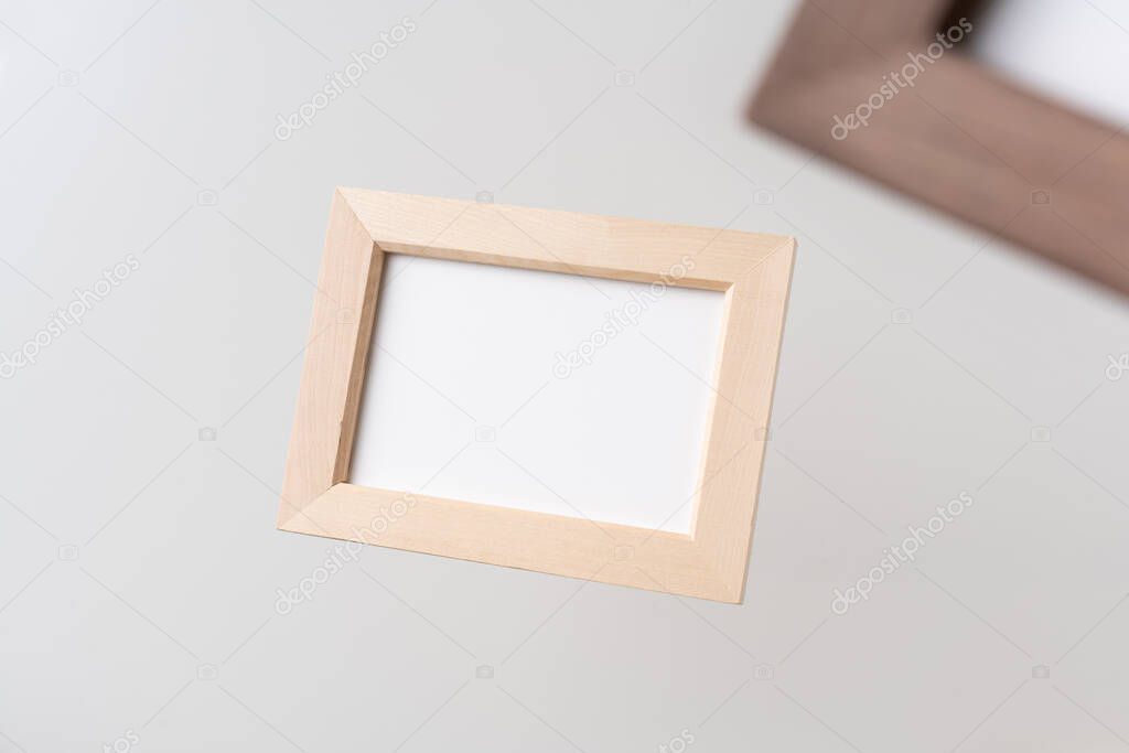 Design concept - top view of two brown wood photo frame float on mid air with blur effect isolated on white background for mockup, it's real photo, not 3D render
