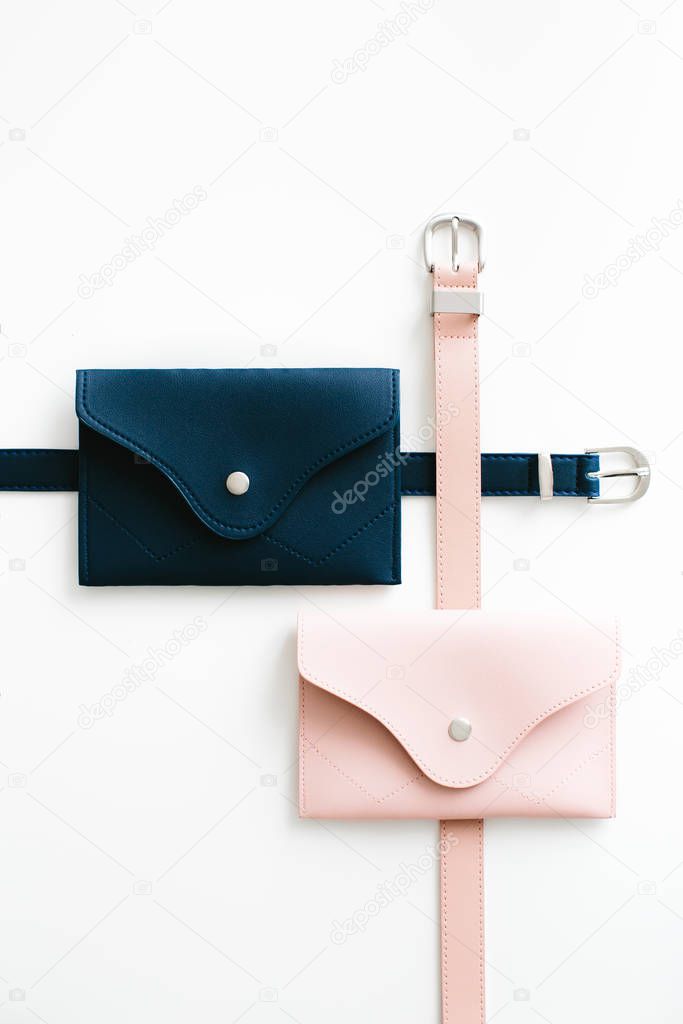 Blue and pink waist bags on a white background