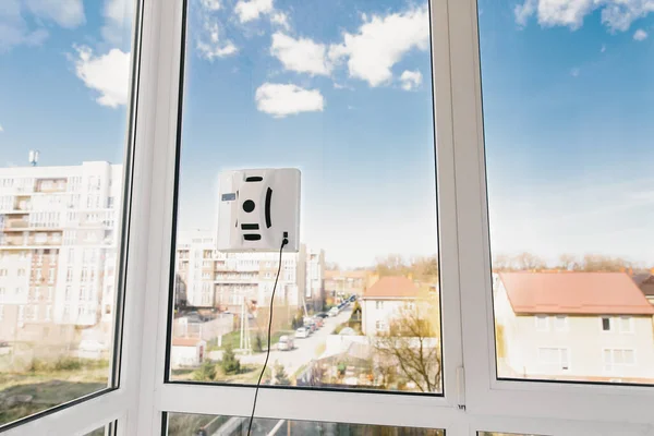 Vacuum robot washes window. Concept cleaning. Robot assistant at home.