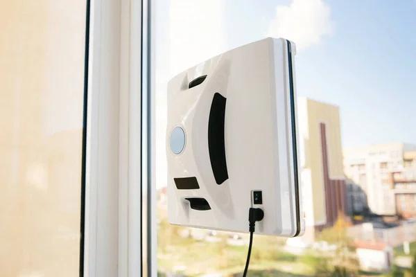 Vacuum robot washes window. Concept cleaning. Robot assistant at home.