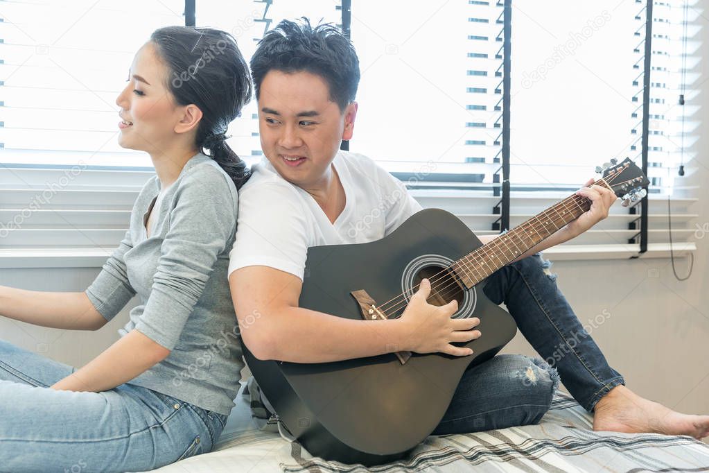 Young Couple playing guitar 
