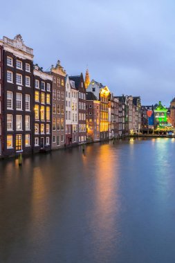 Amsterdam Canals and Saint Nicholas church at dusk in Netherlands clipart