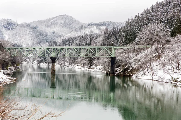 Train in Winter landscape snow on bridge