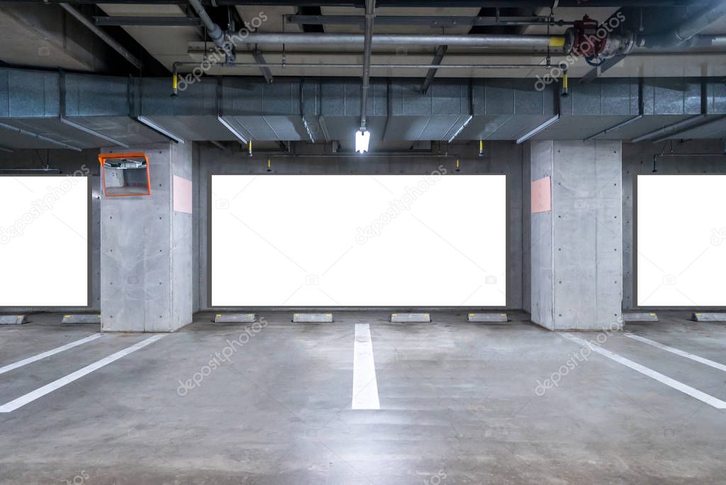 empty Parking garage underground with blank billboard, interior shopping mall at night