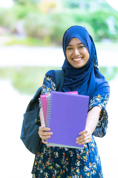 幸せそうな若いです10代のイスラム教徒のイスラム教徒の大学の女の子の肖像知識と知恵の概念のための彼女の本を保持 — ストック写真
